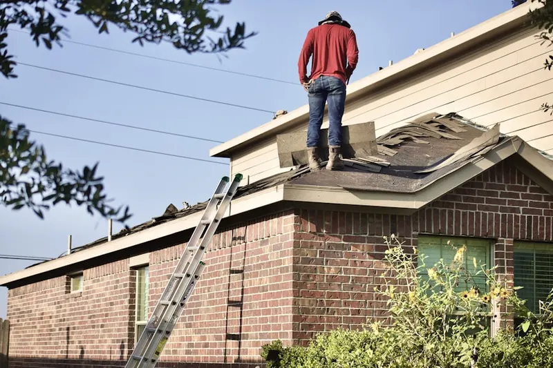 Professional roofer working on a residential roof in Mooreville